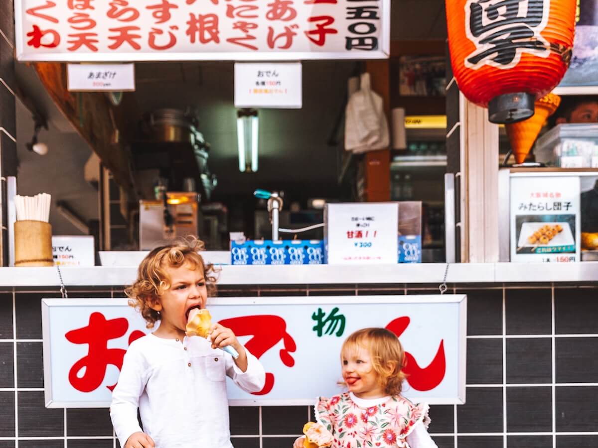 Kids eat ice cream on the street in Kamakura Japan