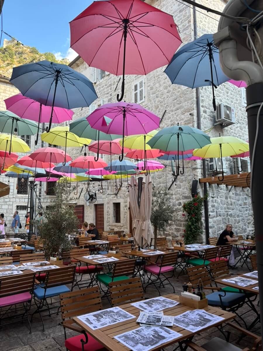 Umbrellas decorate al fresco dining in the streets of Kotor