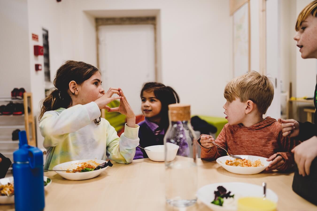 A group of children from Boundless Life talk over lunch - showing confidence in their travel adventure