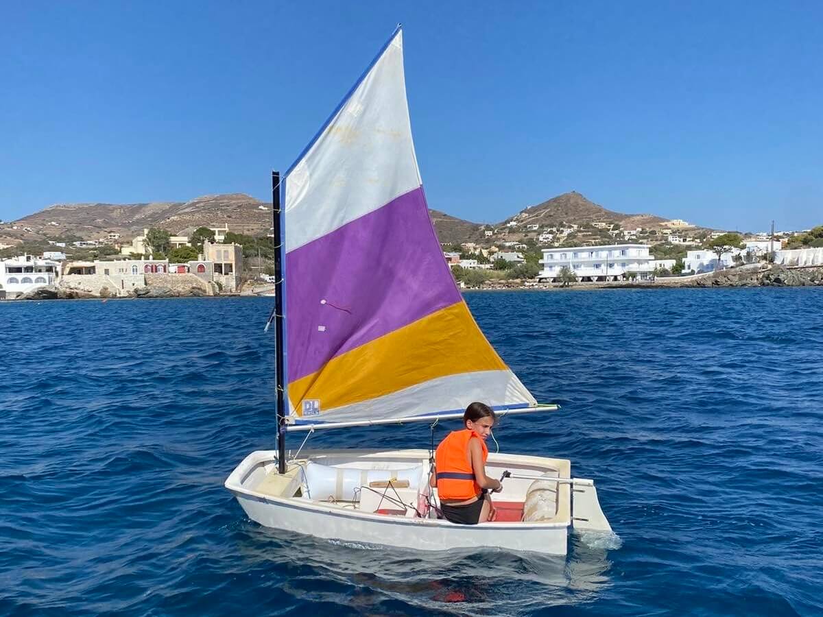 A young child from Boundless Life tries sailing in Syros Greece
