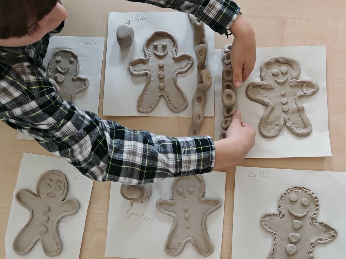 Pottery gingerbread men lined up to dry