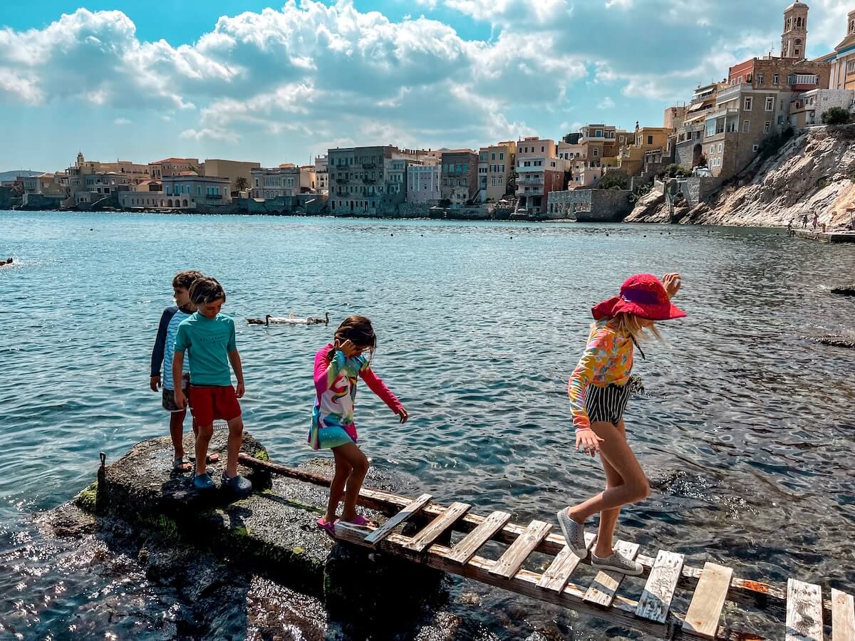 A group of kids go for a walk and explore the destination that are traveling in.