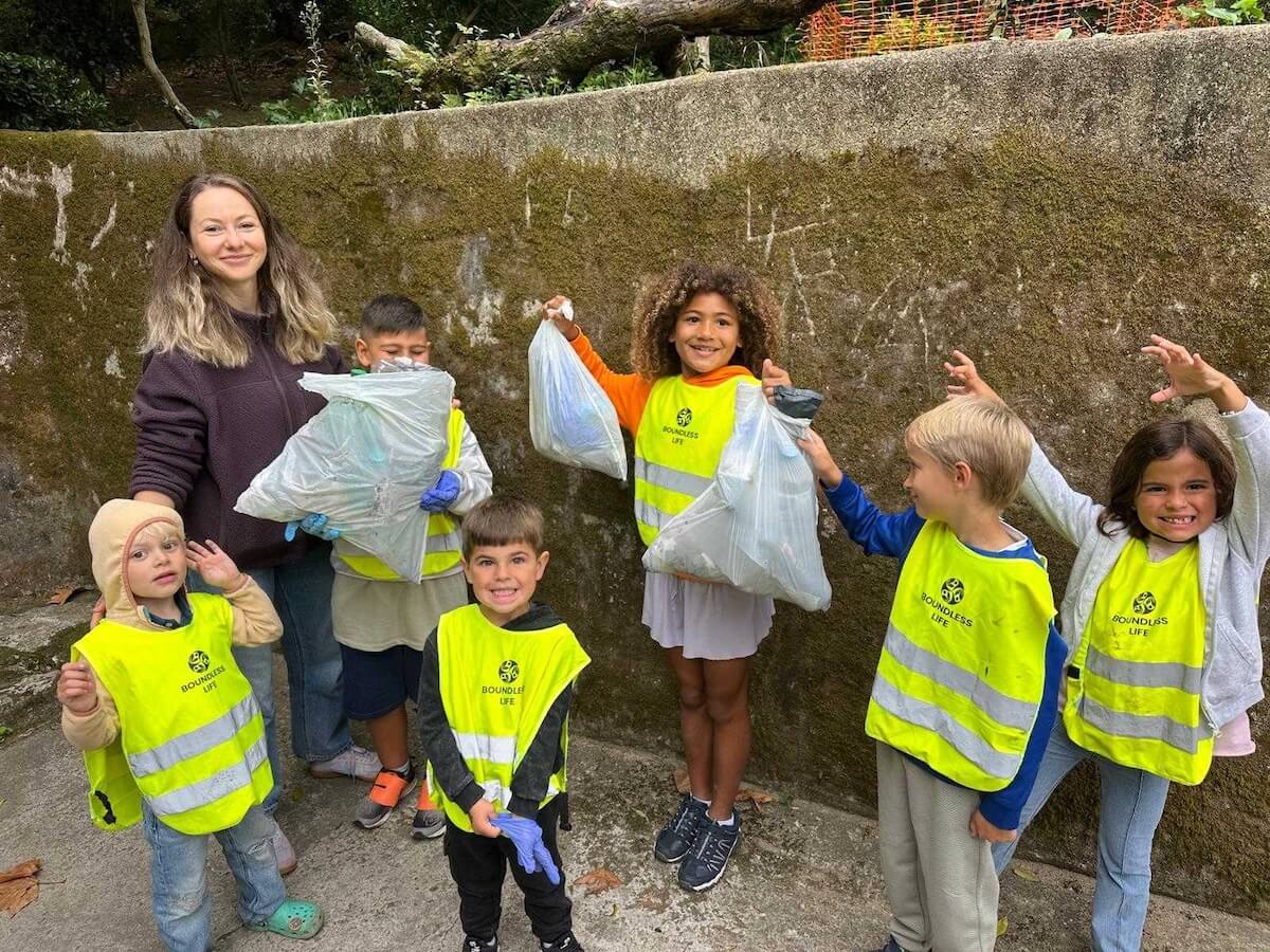 A group of Boundless Life kids show how much trash they collected on a community clean up.