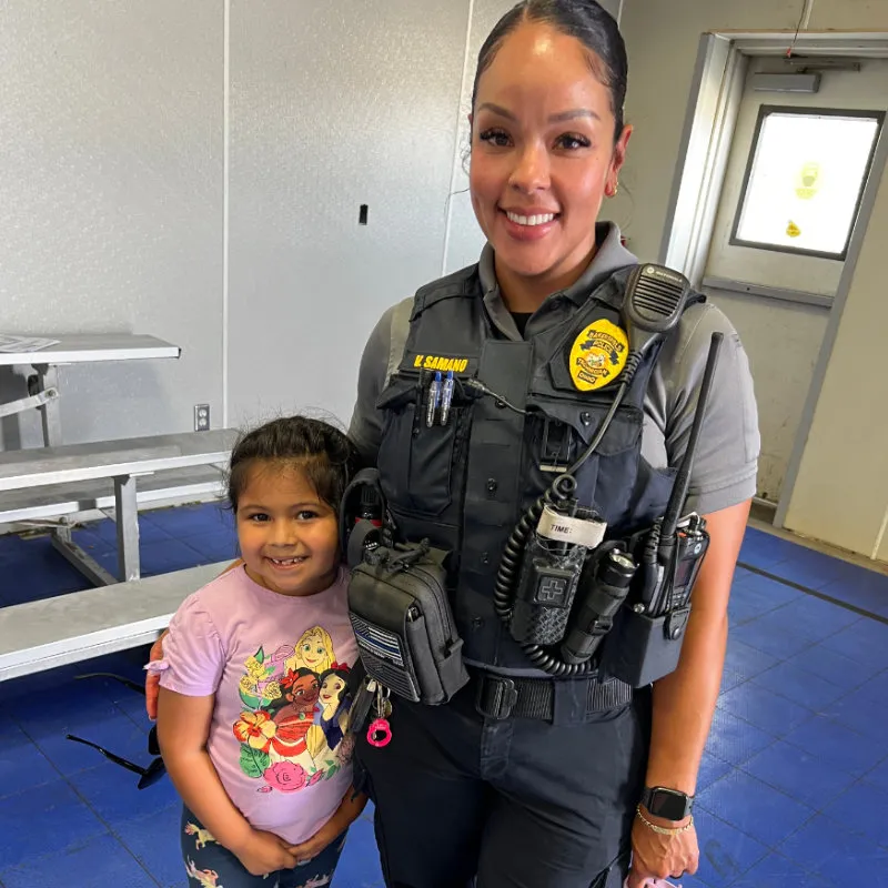 Officer with K9 and two girls