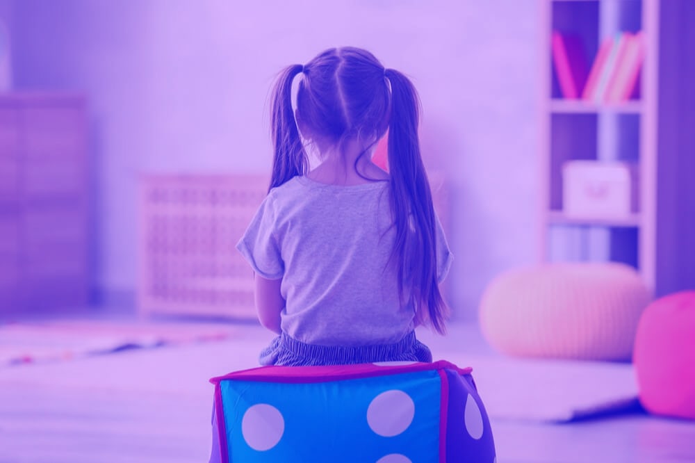 A girl is sitting behind