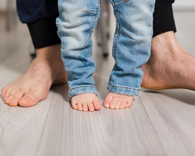 child toe walking with fathe