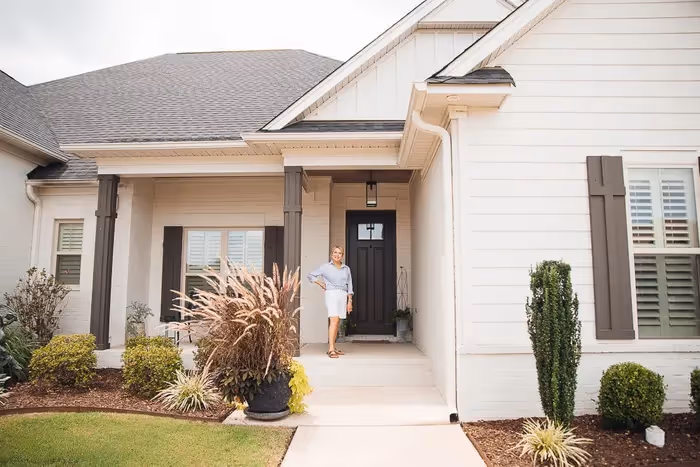 Woman standing in front of her house built by Watson Homes