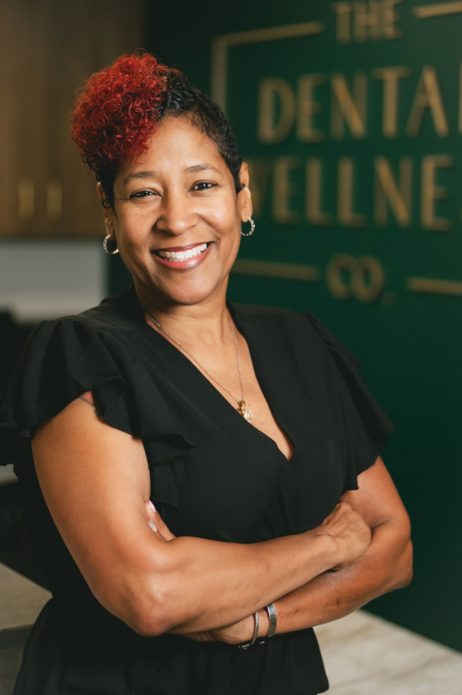 Female team member smiling confidently at The Dental Wellness Co office