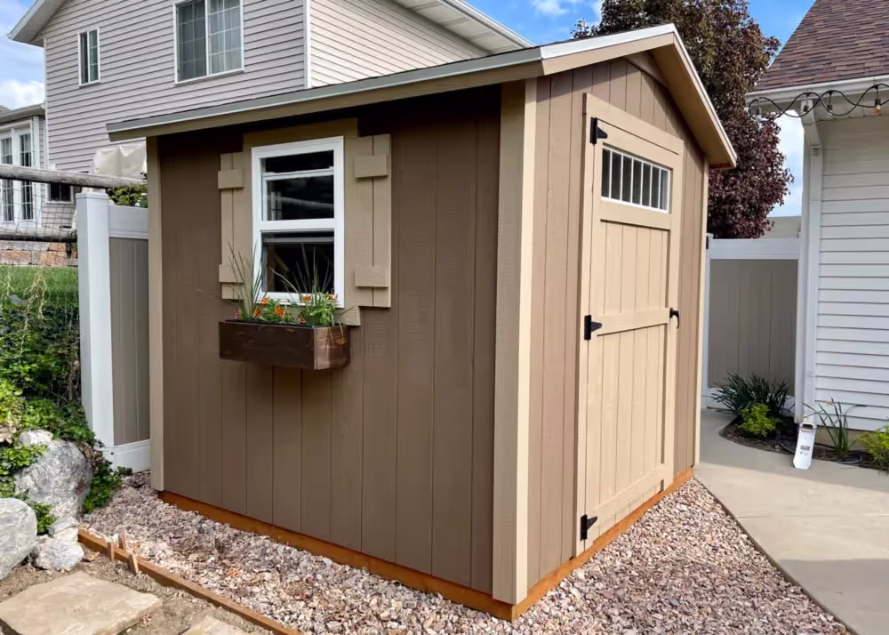 A cute 8 foot by 8 foot standard apex with a 6 inch roof overhang and a transom window in the door