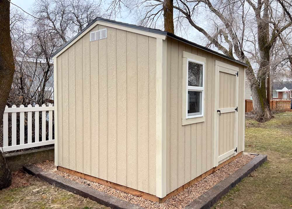 An 8 foot by 12 foot standard apex shed with a single door and a window on the side wall