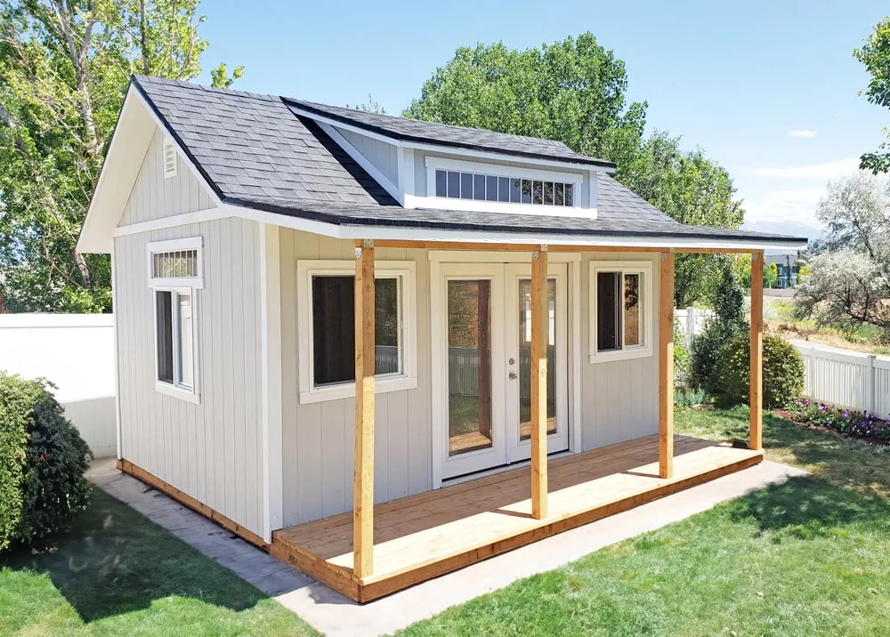 A 12 foot by 16 foot Tall Apex shed with a dormer and a porch