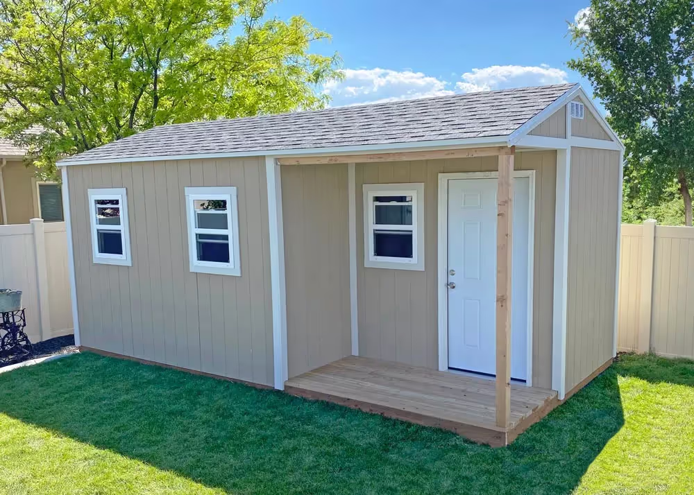 A custom 10' x 20' Tall Apex storage shed with a corner porch