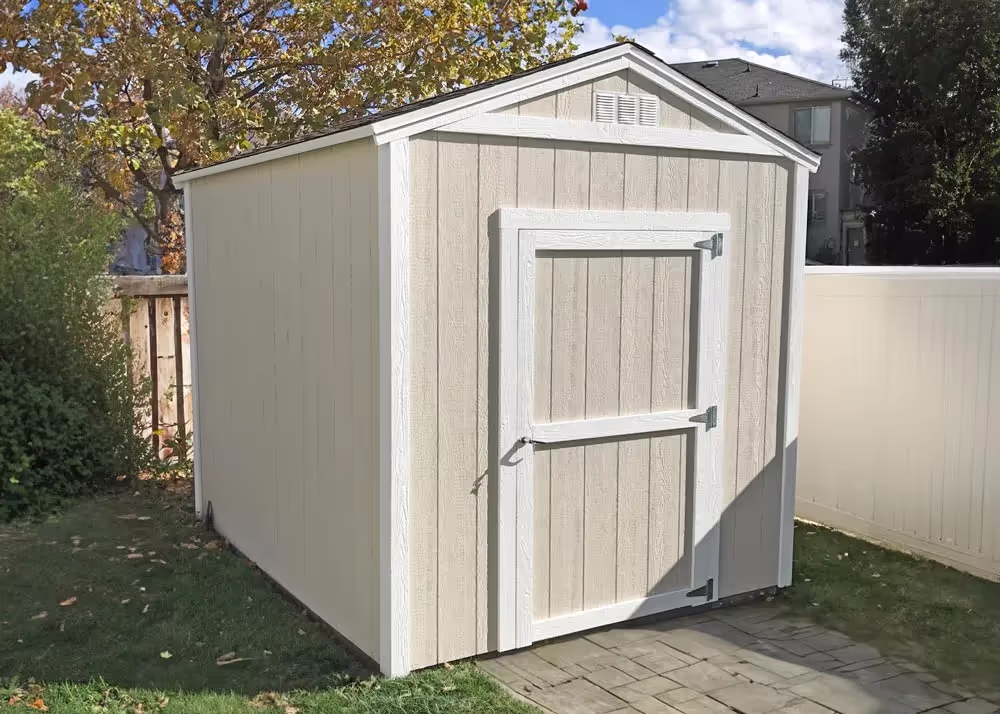 A basic 8' x 12' Tall Apex storage shed painted tan and white
