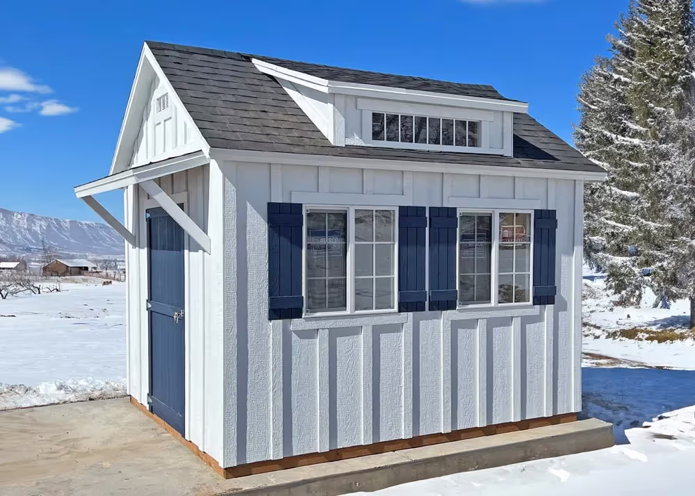 A 10 foot by 12 foot Custom Tall Apex with board and batten siding and a porch awning