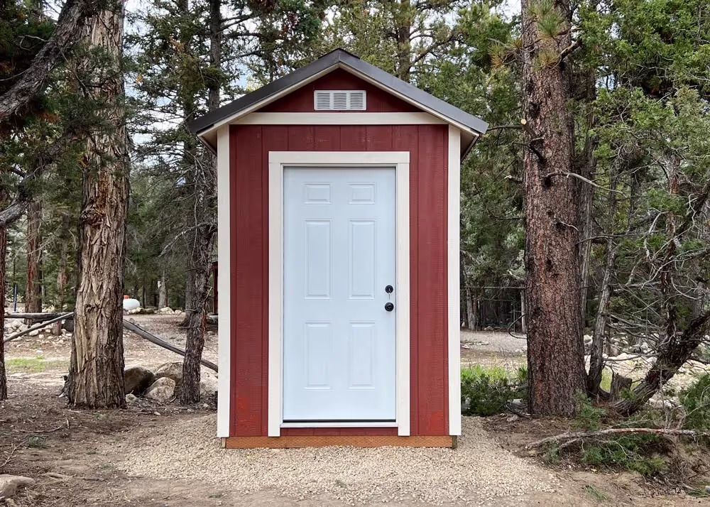 A 6 by 8 Tall Apex with a steel entry door and 6 inch roof overhang