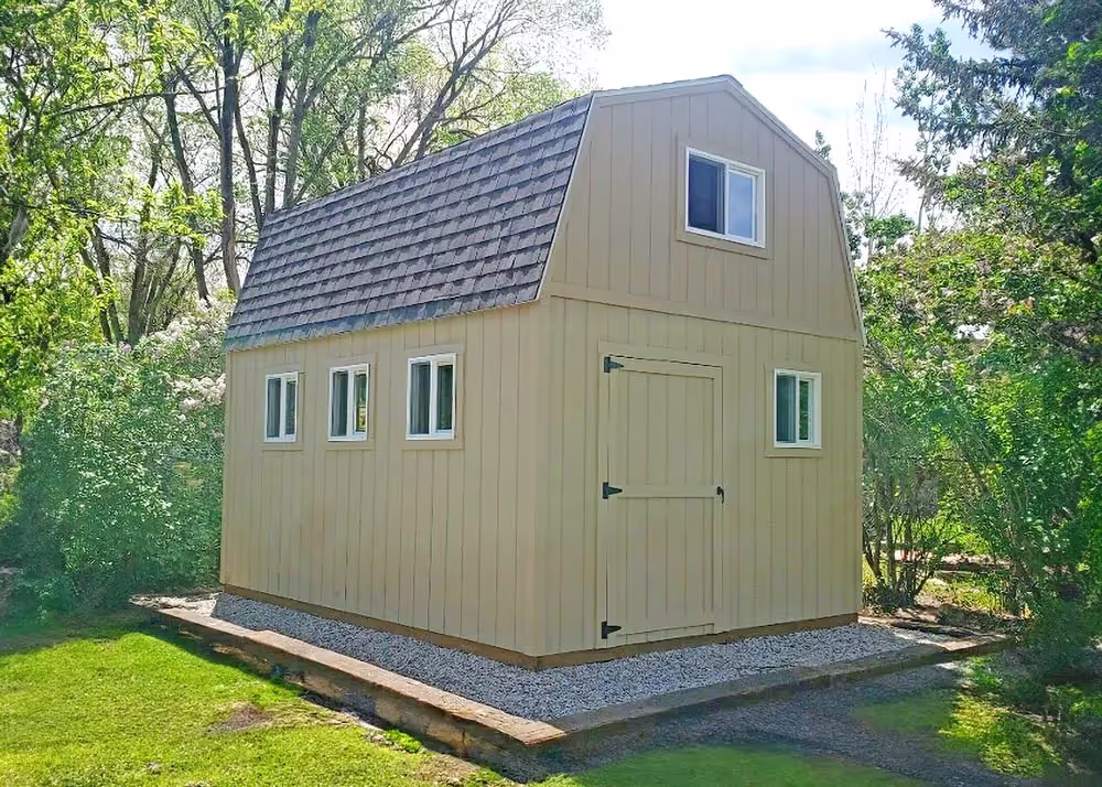 An unpainted 10 foot by 20 foot Tall barn shed with lots of windows