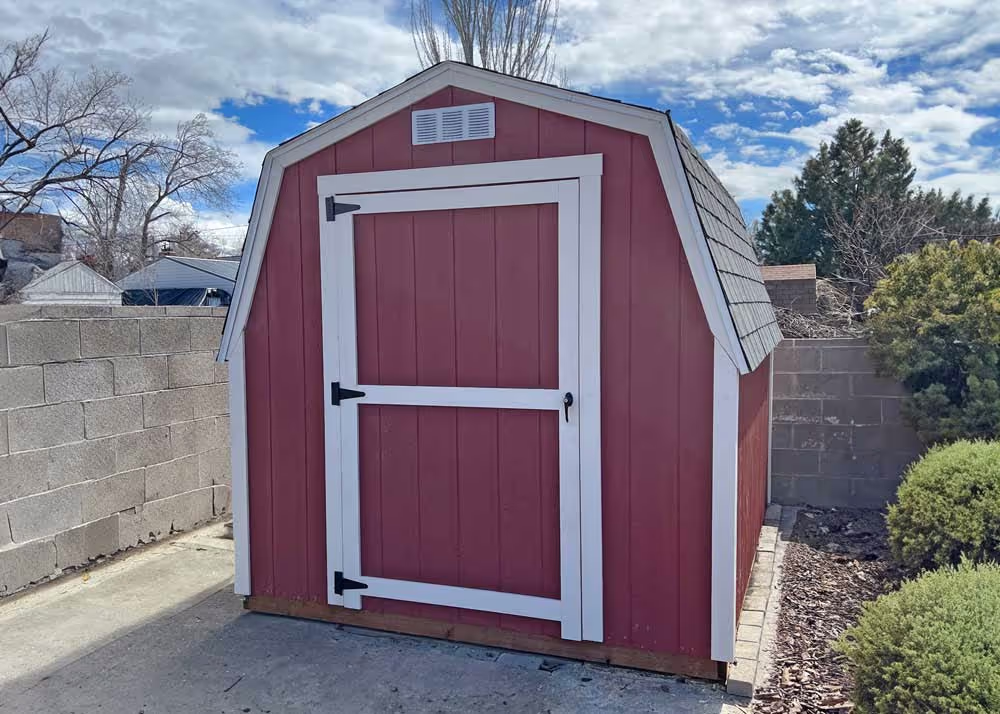 An 8 foot by 8 foot mini-barn storage shed in red and white