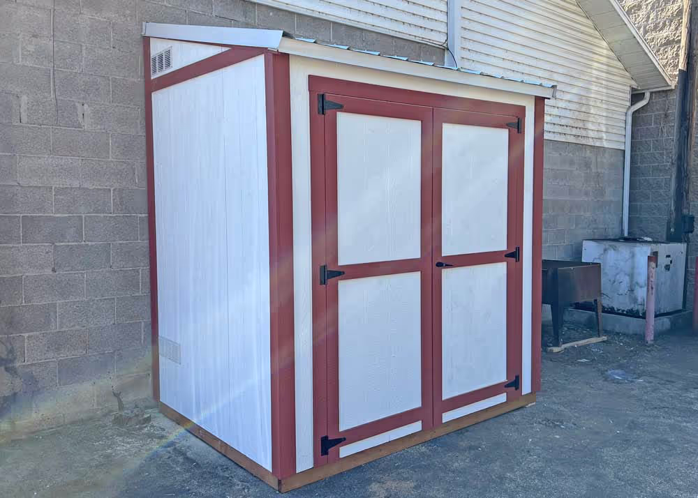 A small 4 foot by 8 foot lean-to style shed with a metal roof