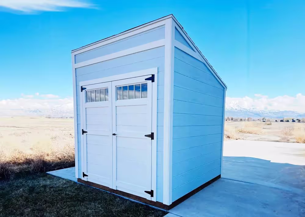 An 8 foot by 8 foot Lean-To shed with horizontal siding and a 6 foot double door with transom windows