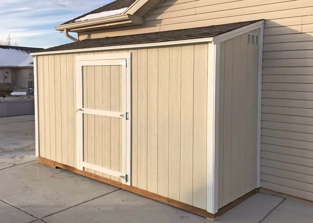 A 4 foot by 14 foot lean-to style storage shed against a house