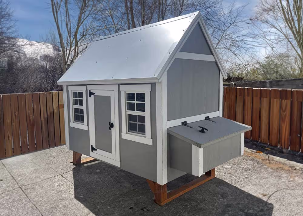 A large hen hut chicken coop in Sage green and white