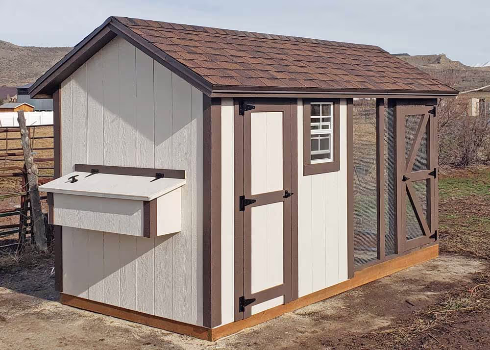 A Cream and brown 6 foot by 12 foot Coop De'Ville chicken coop