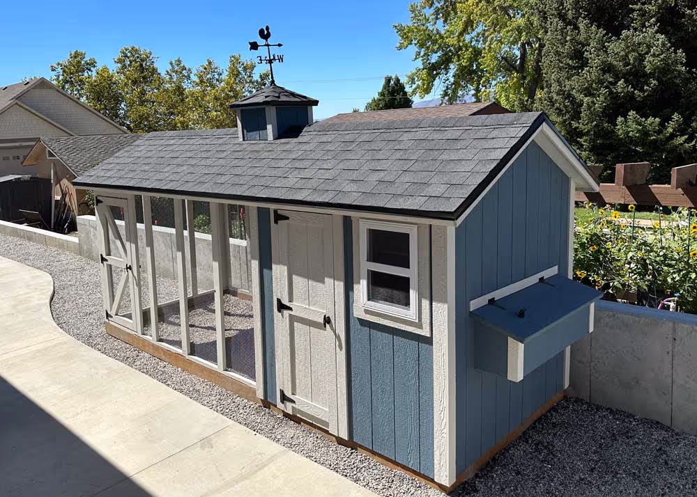 A 6 foot by 16 foot Coop De'Ville chicken coop showing nesting box on end