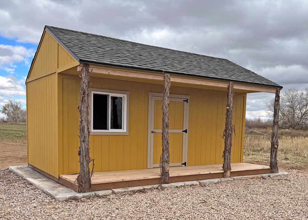 A 14 foot by 20 foot Tack shed with a custom roof pitch and cedar posts