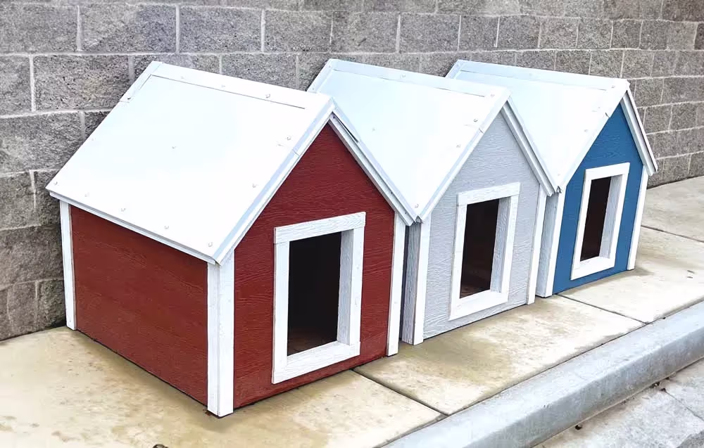 three of our high quality dog houses lined up in a row.