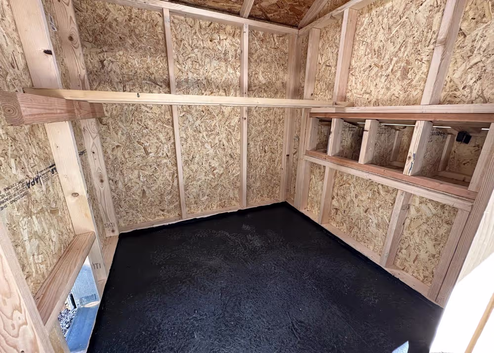 The interior of a Coop De'Ville chicken coop with a Flexseal Rubber Floor coating