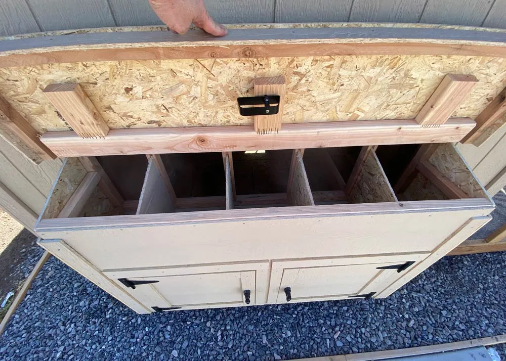 A Nesting box cabinet with an open lid to show the dividers