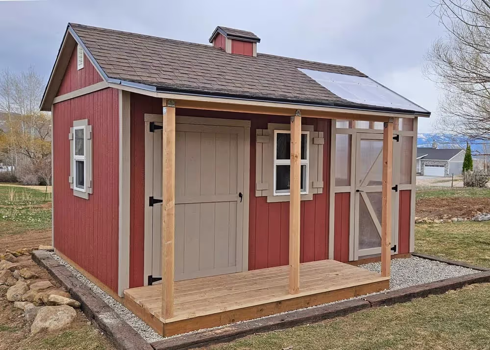 A very custom 12 foot by 16 foot shed and greenhouse combo with a porch