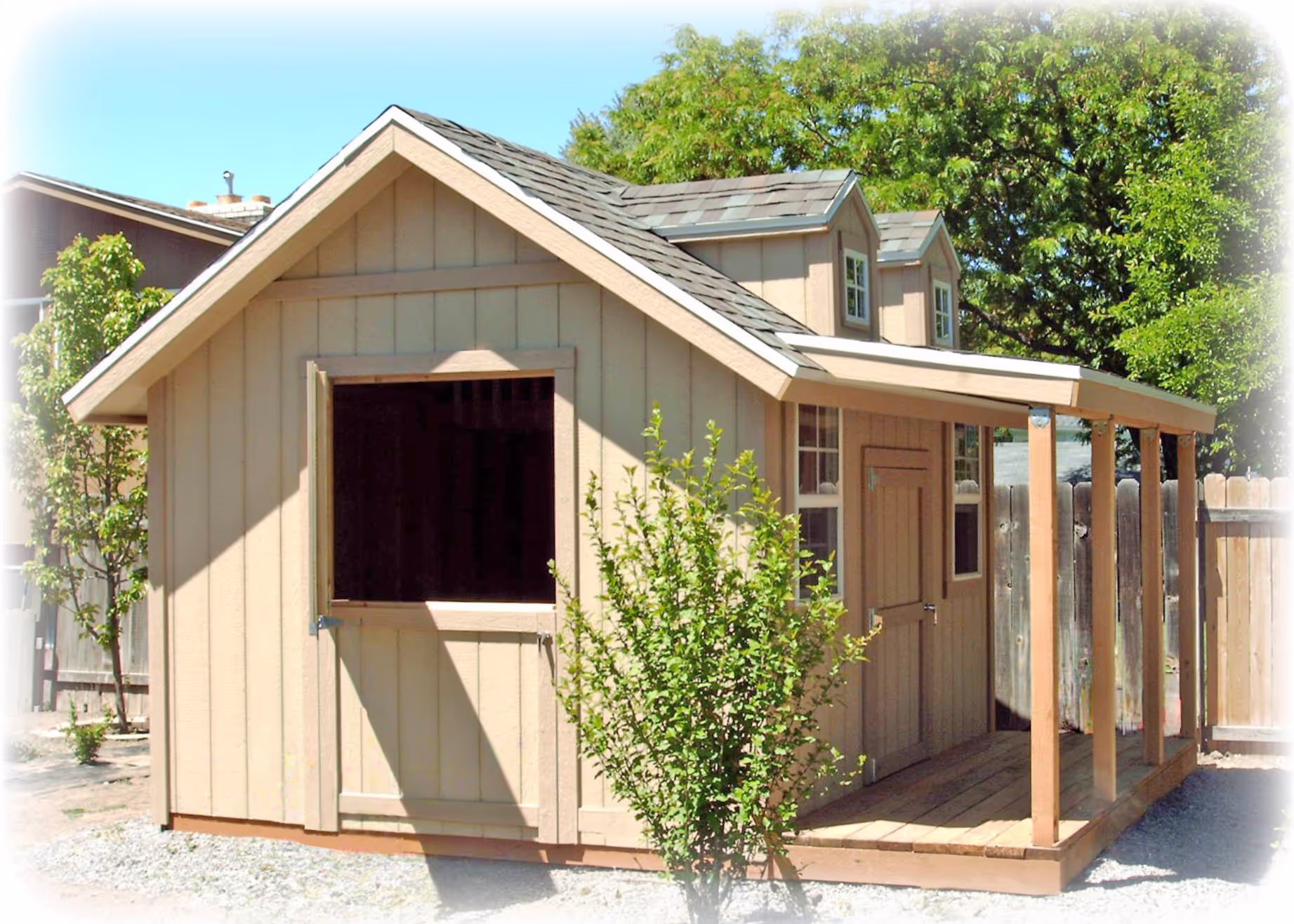 A custom playhouse with double a-frame dormers, a porch and a dutch door
