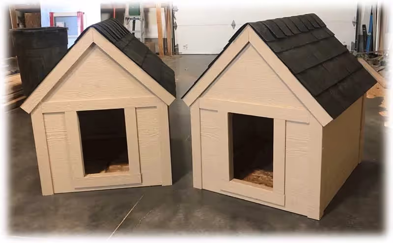 An Extra Large Dog house painted red and tan with a shingled roof