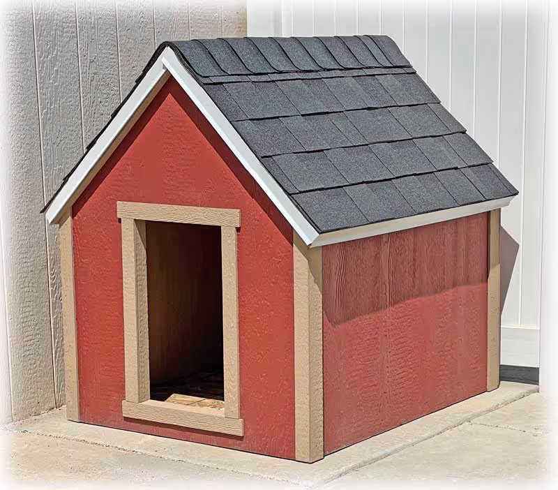 A red and tan dog house with a shingled roof
