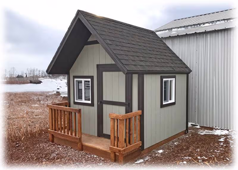 A clubhouse playhouse with a porch and porch railing painted tan and brown