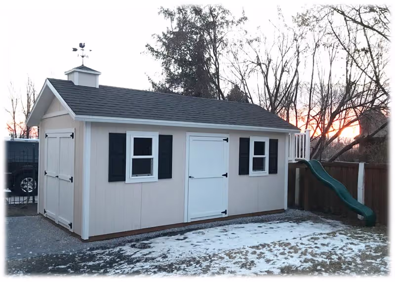 A custom shed and playhouse combination with a deck and a slide on one end.