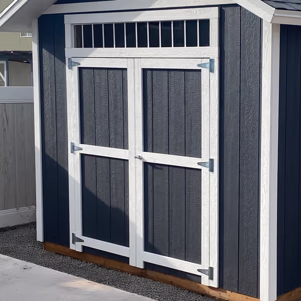 A 6' wide double door with a 72" transom window above it on a tall apex shed