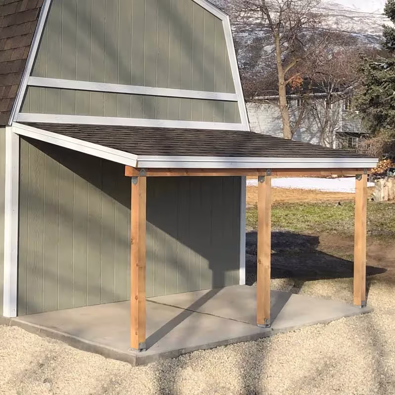 A porch overhang added to the back of a Standard Barn shed for covered storage space