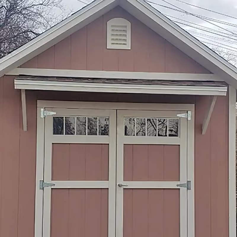 A porch awning over a set of 6' wide double doors with transom windows in them