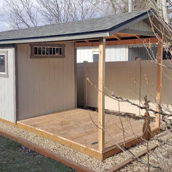A roof extension over a deck on a Tall Apex Shed.