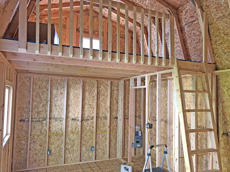 A Tall Barn Cabin shed with a loft with railing and a ladder