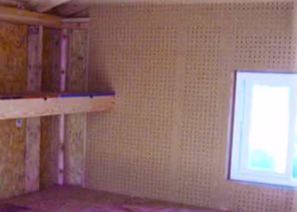 Shed interior with a pegboard wall for efficient tool storage, keeping essentials organized and accessible.