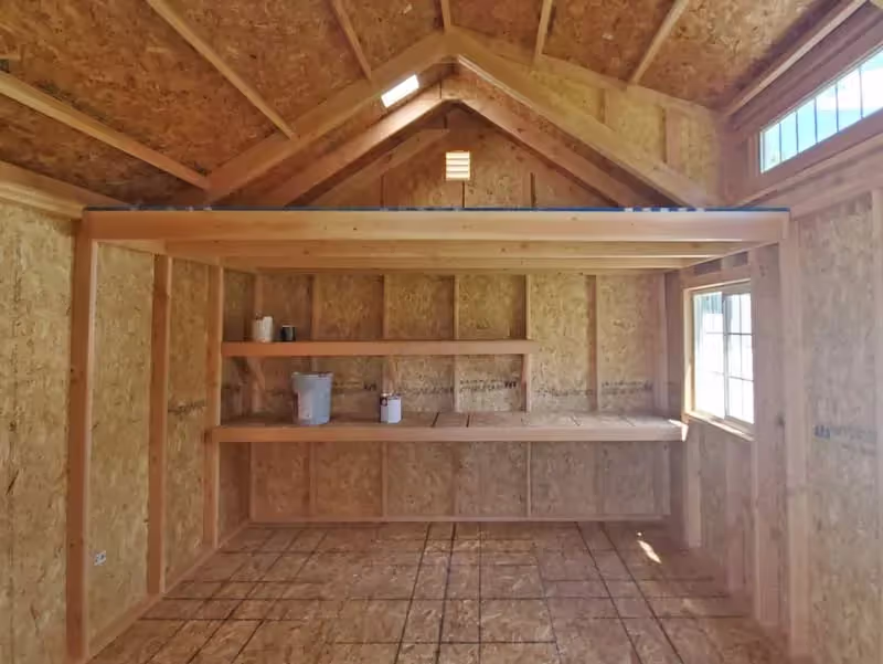 Tall Apex Shed interior with a loft and shelves for efficient storage, maximizing space with a durable design.