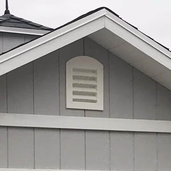 Arched wall vent installed in shed gable for enhanced airflow and ventilation