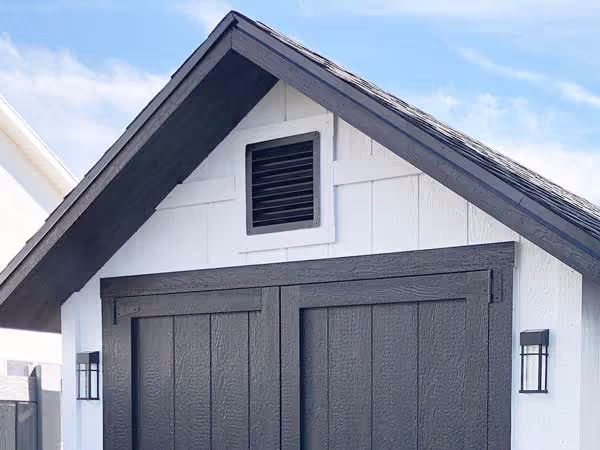 12" x 12" aluminum wall vent installed on a shed, providing durable and efficient airflow ventilation.