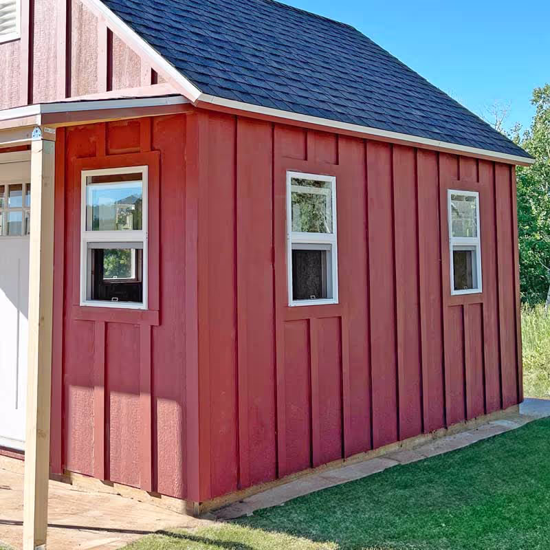 A custom shed with our board and batten siding upgrade and a porch overhang