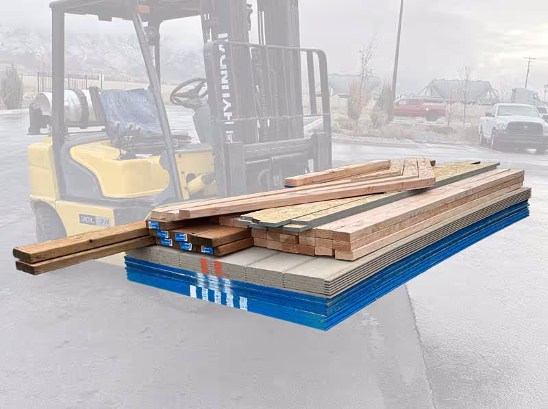 A partially prefabbed do it yourself shed kit on a forklift