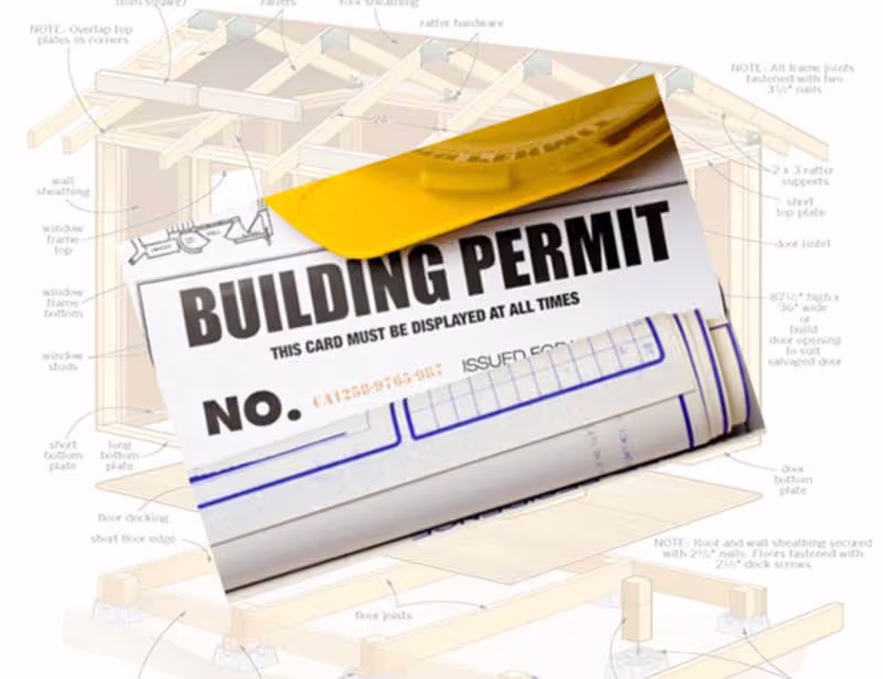 A building permit over the top of a set of shed plans