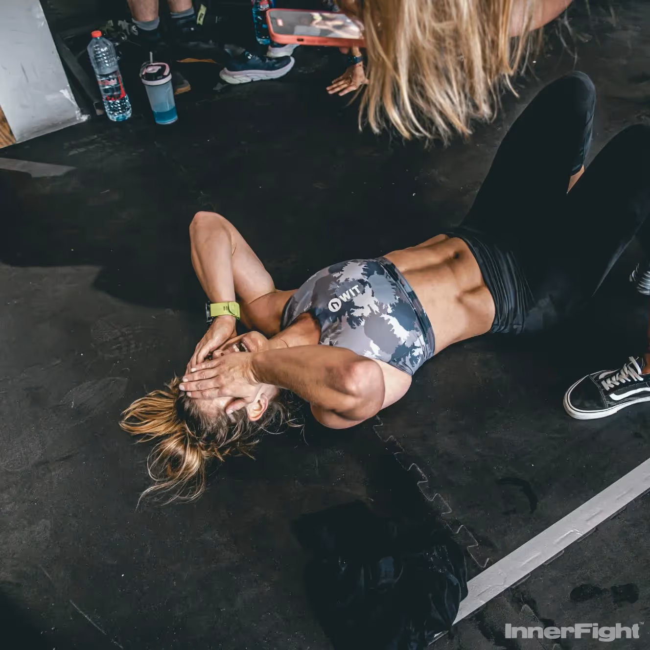 Woman on the floor exhausted after a workout